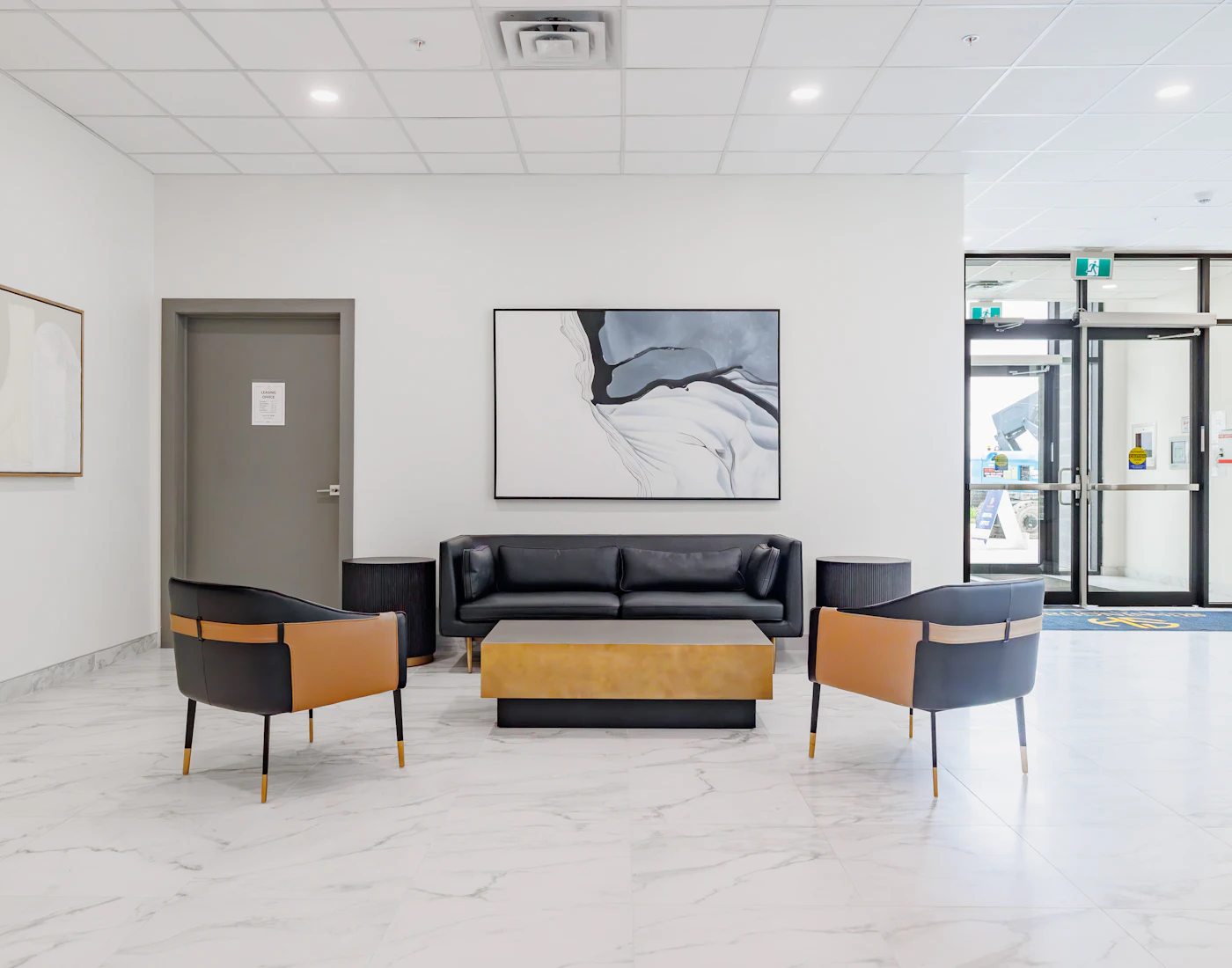 Tidy office waiting area with chairs and a coffee table